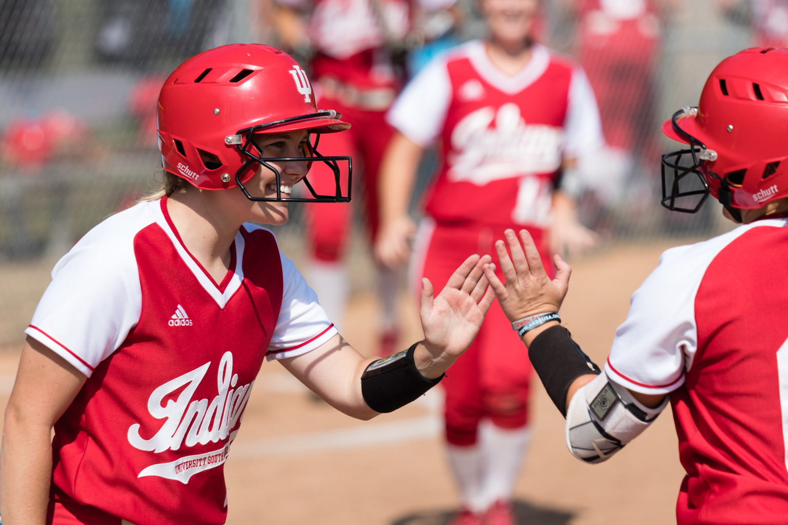 Softball players high fiving